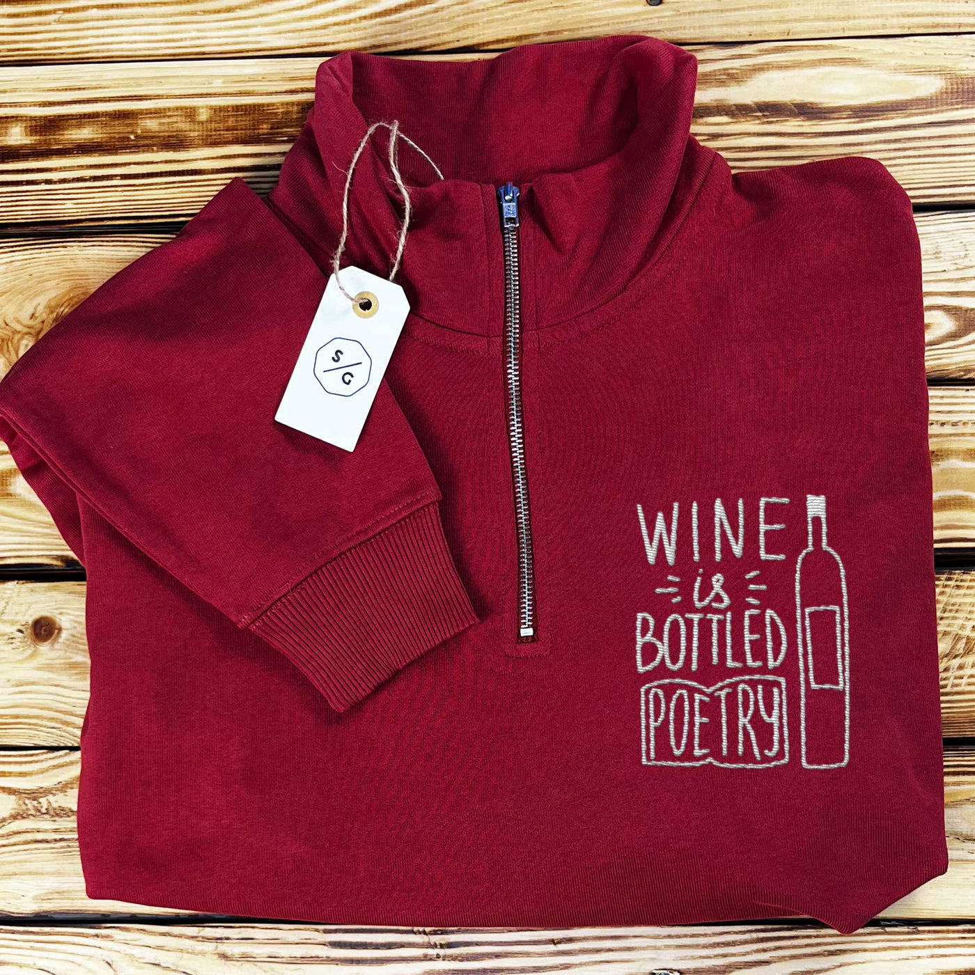 EMBROIDERED HALF-ZIP SWEATER • WINE IS BOTTLED POETRY